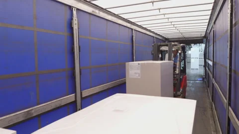 Warehouse forklift driver loading boxes in cargo shipping container Stock Footage 248647910