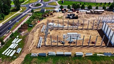 Warehouse Frame Construction Site Beside Road Roundabout, Drone Flyover Stock Footage 341543700