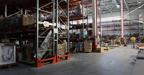 Warehouse full of goods with man in the background Stock Footage 84877002