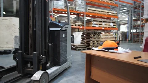Warehouse with goods. The camera in motion, accompanied by a forklift. 4K Slow Stock-Footage 111765963