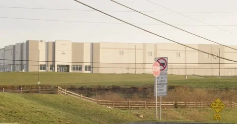 Warehouse on Grassy Hill During Sunset Stock Footage 321795579