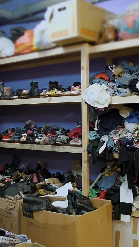 Warehouse. humanitarian aid. second hand. Shelves with donated things and Stock Footage 315440906