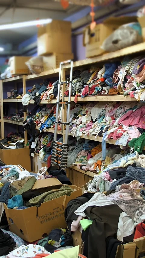 Warehouse. humanitarian aid. second hand. Shelves with donated things and Stock Footage 315942195