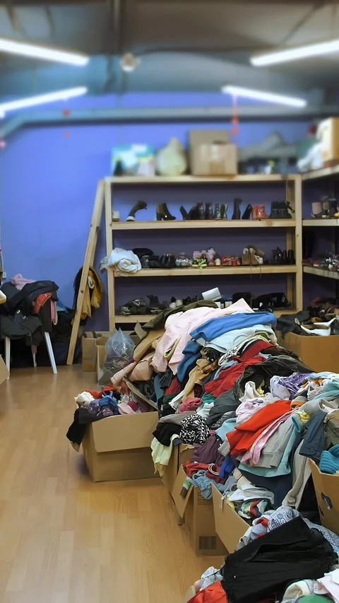Warehouse. humanitarian aid. second hand. Shelves with donated things and Stock Footage 316261510