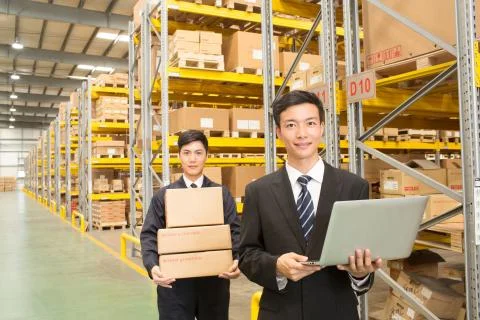 Warehouse Indoor 25 to 30. Take it. Male businessman Adults only Work Happy box Stock Photos