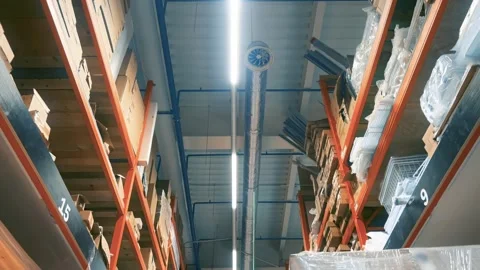 Warehouse Interior POV: Worker Walks Central Aisle. Shelves with Cardboards Stock Footage 281610198