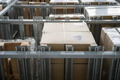Warehouse interior with racks and boxes. Interior shot of a warehouse with hi Stock Photos