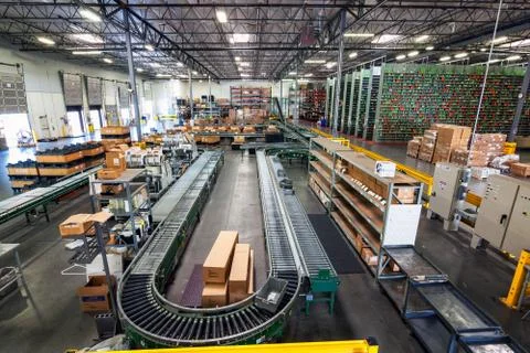 Warehouse interior stacked boxes and conveyor belts Stock Photos
