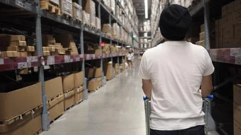 Warehouse large storage or cargo for distribution and man's back with shoppin Stock Photos