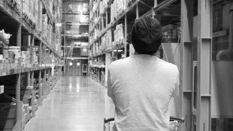 Warehouse large storage or cargo for distribution and man's back with shoppin Stock Photos