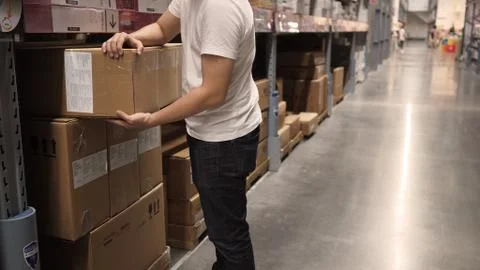Warehouse large storage or logistic or cargo for distribution. and man's hand Stock Photos