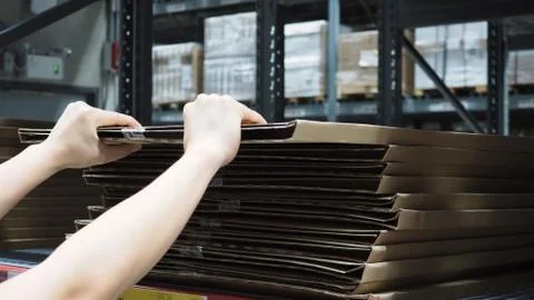 Warehouse large storage or logistic or cargo for distribution. and man's hand Stock Photos