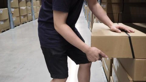 Warehouse large storage or logistic or cargo for distribution. and man's hand Stock Photos