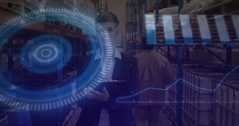 Warehouse lead tapping tablet walking aisle, showing HUD chart, picker passing, Stockbeeldmateriaal 331833342