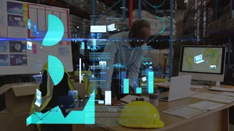 Warehouse lead using laptop, showing AR data over desk, reviewing docs and Stock Footage 335638699
