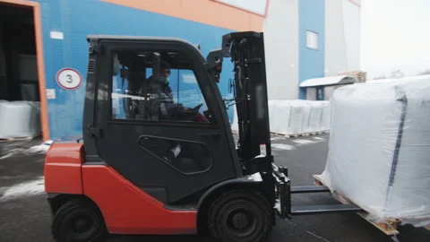 Warehouse loader moves building materials by forklift Stock Footage 231216602