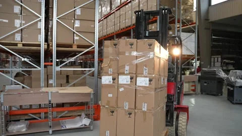 Warehouse loader riding with large pallet of boxes 스톡 동영상 161954460