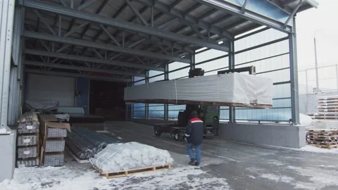 Warehouse loader transports polycarbonate panels in hangar Stock Footage 228781079