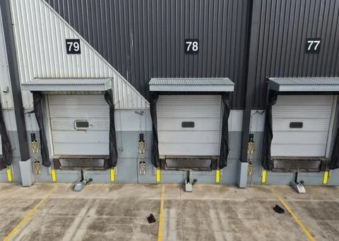 Warehouse loading dock doors with numbers 77, 78, 79 Fotos de archivo