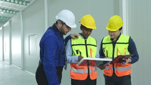 The warehouse manager advises the two employees Stock Footage 255274549