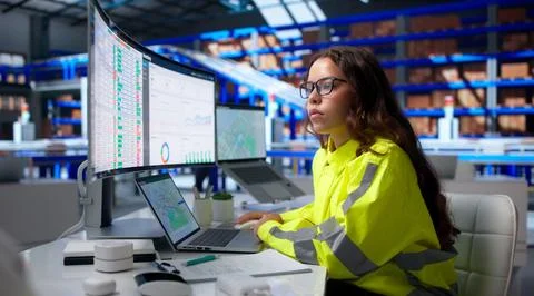 Warehouse Manager Analyzes Digital Reports On Laptop To Improve Parcel Handli Stock Photos