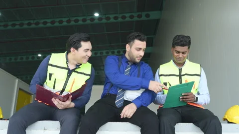 A warehouse manager and two employees are resting Stock Footage 255275046
