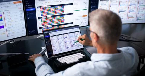 Warehouse Manager Checks Inventory Data On Laptop To Improve Workflow. Stock Photos