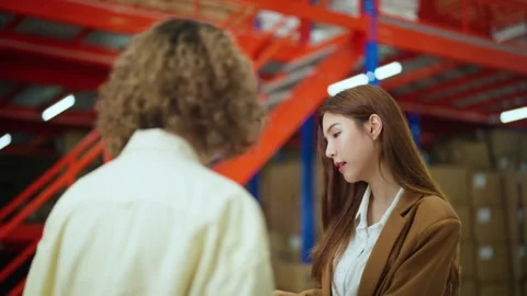 Warehouse Manager Discussing Operations with Worker. Stock Footage 277543161