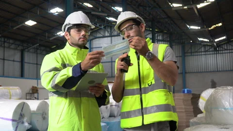 Warehouse manager discussion with Product quality inspector warker checking q Stock Footage 144266859