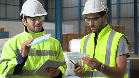 Warehouse manager discussion with Product quality inspector warker checking q Stock Footage 144268231