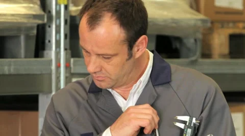 Warehouse Manager / Warehouse Worker with a caliper Stock Footage 11900047