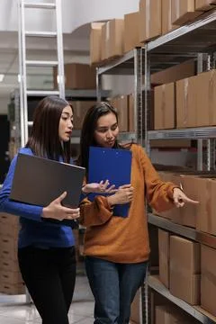 Warehouse managers checking goods maintenance in storage room Foto stock