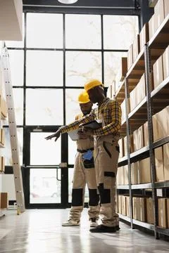 Warehouse managers checking parcels stock using orders checklist 스톡 사진
