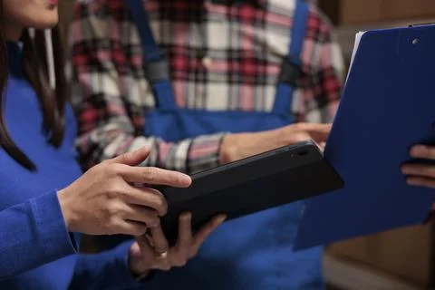 Warehouse managers tracking parcel on digital tablet Stock Photos