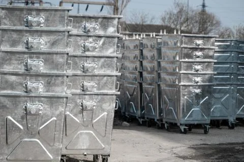 Warehouse of a new silver garbage containers. Stock Photos