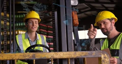 Warehouse operator driving forklift, trainer pointing and using tablet, AR Stock Footage 330960080