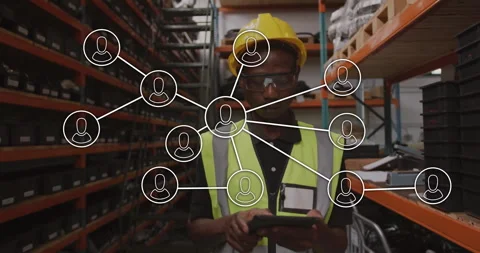 Warehouse operator tapping tablet and projecting network then fading nodes for Stockbeeldmateriaal 310153550