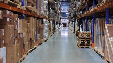 Warehouse or hangar storage racks or shelves with boxes and goods. Industrial Stock Footage 90225022