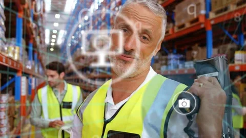 Warehouse picker reaching for box and scanning barcode, activating HUD icons and Stock Footage 333873103