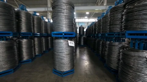 Warehouse rolls of wire . wound wire at the factory. Iron proloco wound into Video stock 94899391
