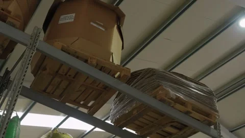 Warehouse shelving rack with cardboard boxes and pallets at recycling factory Stock Footage 334280391