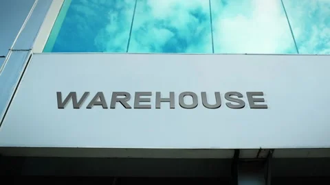 Warehouse Sign on Modern Building with Cloud Reflection on Windows Glass Stock Footage 303570636