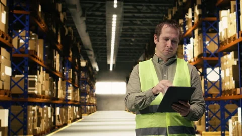 Warehouse staff with tablet handling cardboard boxes for order fulfillment Stock Footage 332906868