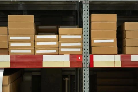 Warehouse stocked with boxes in stacks Stock Photos