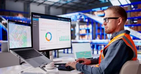 Warehouse Supervisor Monitors Digital Systems To Manage Automated Logistics O Stock Photos
