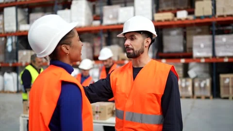 Warehouse supervisor shaking hands with female employee Stock Footage 320995502