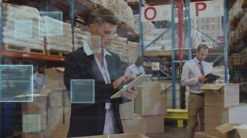 Warehouse supervisor tapping tablet, activating blue UI overlays, team stacking Stock Footage 334202651