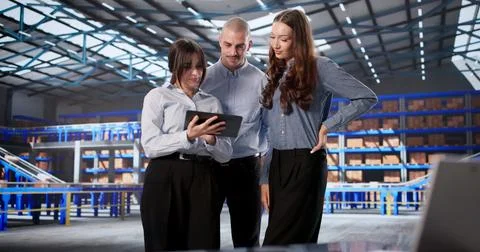 Warehouse Team Collaborates Using Digital Tablet For Logistic Management Effi Stock Photos