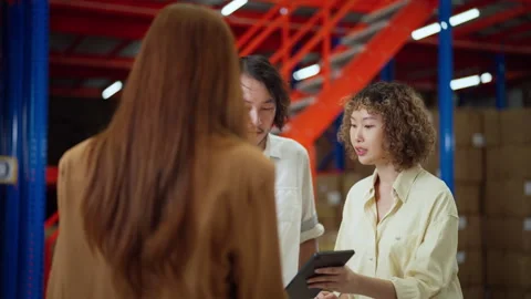 Warehouse Team Discussing Logistics with Digital Tablet. Stock Footage 279405219