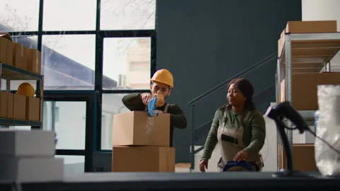 Warehouse trainee seals boxes parcels Stock Footage 251682365